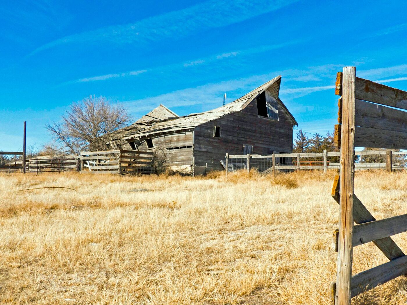 The Roofless Confessor, a heritage structure in managed decline, in open High Plains farmland.