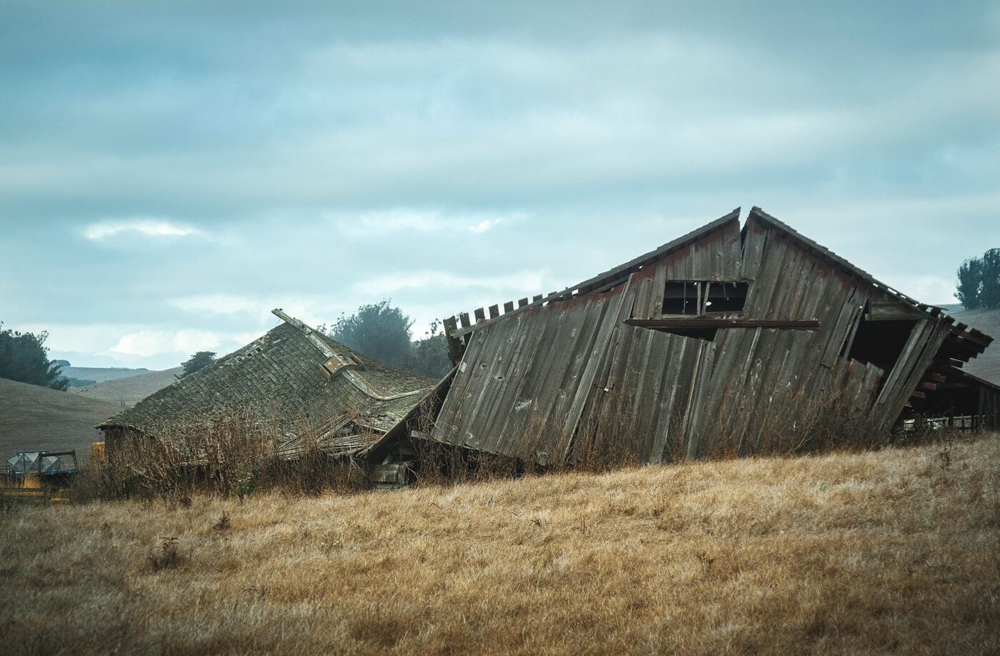 The Widowmaker, a heritage structure in managed decline, in open Upper Midwest farmland.